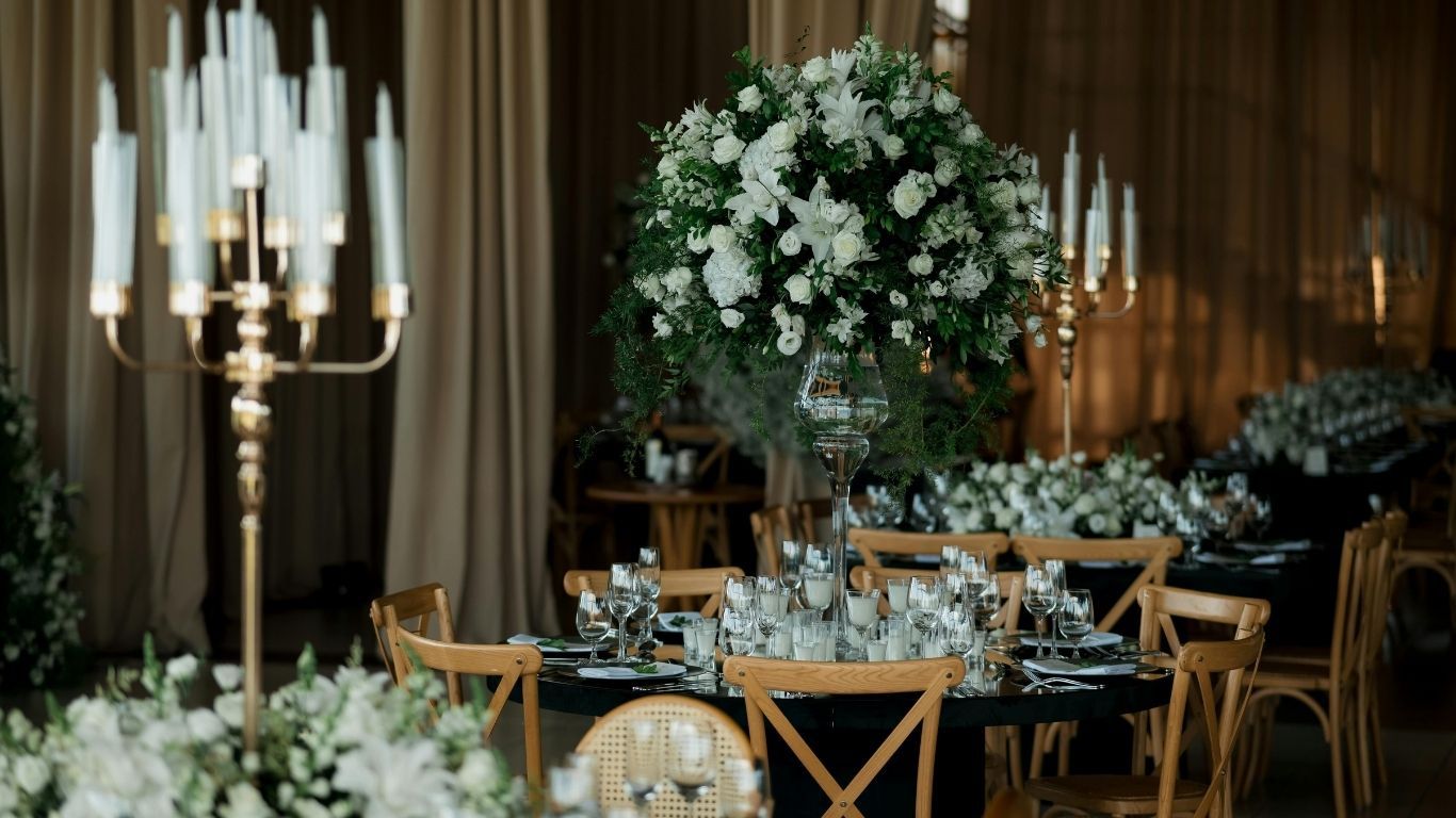 Dark reception table with white floral centerpiece