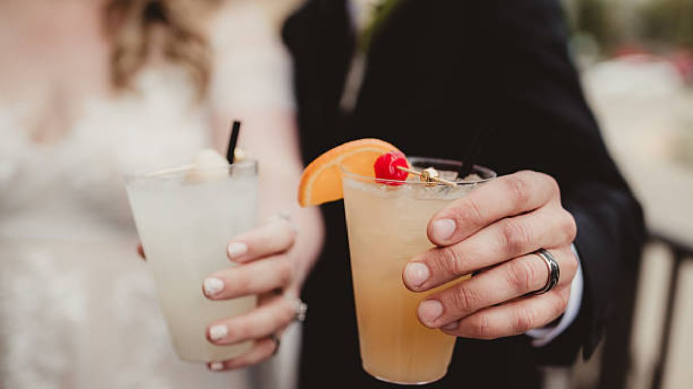 Bride and groom holding signature cocktails